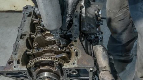 A mechanic working on a car engine in a well-equipped auto repair shop. Car.. 写真素材