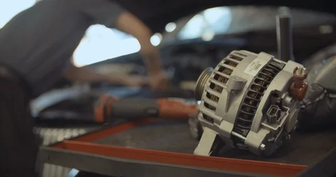 Mechanic Working On Car With Part In The Foreground Vídeo Stock 105248338