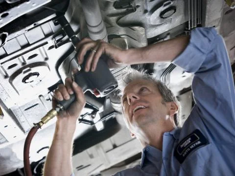 Mechanic working on car Stock Photos
