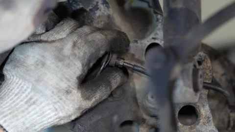 Mechanic Working on Car Suspension Control Arm Stock Footage 345565318