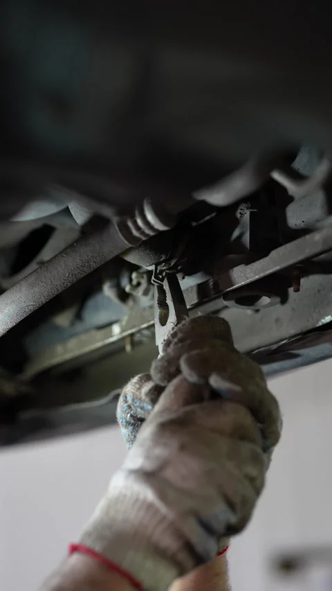Mechanic Working on Car Suspension Control Arm Stock Footage 345567351