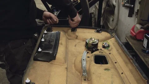 Mechanic working on e36 door card Stock Footage 170697248