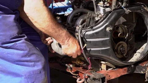 A mechanic working on the engine of a classic car. Detailed process maintenance 스톡 동영상 292439779