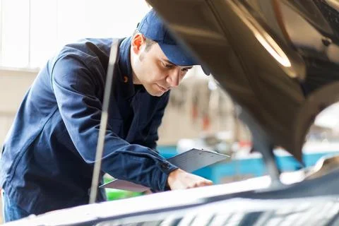 Mechanic working in his workshop Stock Photos