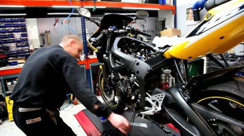 Mechanic working on motorcycleengine Stock Footage 35564250