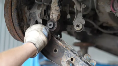 Mechanic Working on Rusty Car Suspension Control Arms Stock Footage 345569049