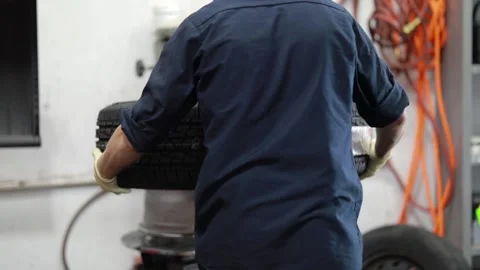 Mechanic Working on a Tire Stock Footage 244365396