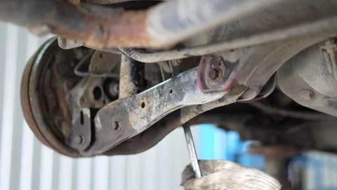 Mechanic Working Under Car Suspension Control Arm 스톡 동영상 345569505