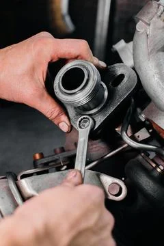 Mechanic Working with Wrench on Engine Component Foto stock