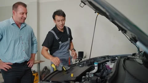 Mechanic works under EV car hood with tools 스톡 동영상 339050346