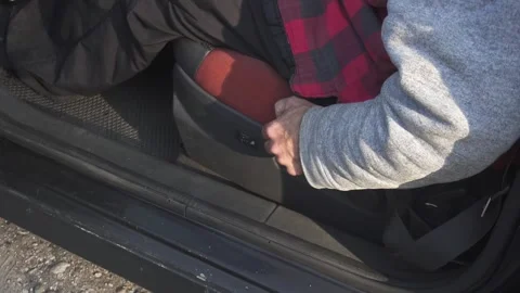 Mechanical adjustment of the height of the driver's seat in the car Stock Footage 296190900