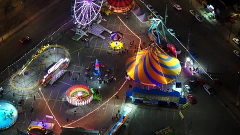 Mechanical amusement rides, such as Ferris wheels, circus tent, and rotating Stock Footage 340417513
