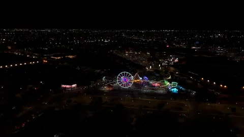 Mechanical amusement rides, such as Ferris wheels, in the Maipu commune Stock Footage 340418516