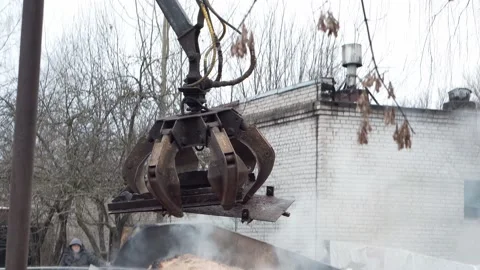 Mechanical arm claw of crane clears blockage of the twisted metal. Stock-Footage 145991503