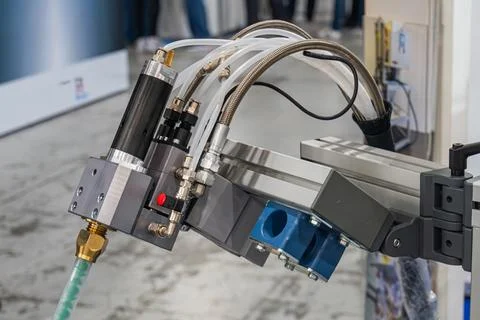 Mechanical arm equipped with cylindrical actuator, hoses, blue filter, moun.. Stock Photos