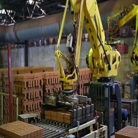 Mechanical arm picks brick Stock Footage 69602363
