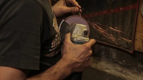 Mechanical assembly fitter work with angle grinder hands close up Stock Footage 115765007