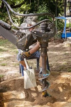 A Mechanical Auger Digging A Post Hole Stock Photos