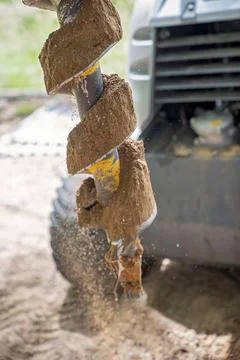 A Mechanical Auger Digging A Post Hole Stock Photos