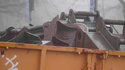 Mechanical Backhoe Thumb Attachments Stored in a Container, Pan Shot Stock Footage 237012957