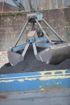 Mechanical bucket picking up a load Stock Photos