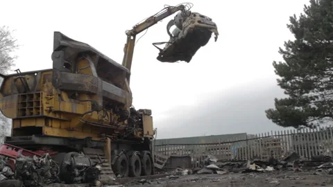 Mechanical Claw Arm dropping crushed car Scrap Metal In breakers yard Stock Footage 162466421