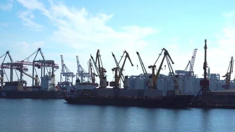 Mechanical cranes unloading cargo from big container ships freight vessels at Video stock 98408401