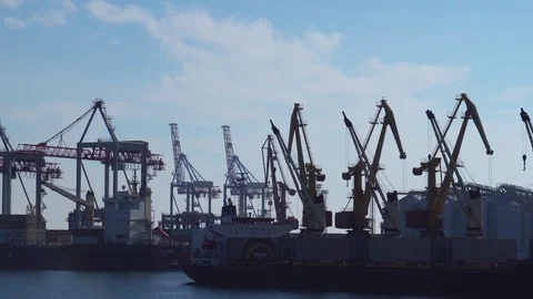 Mechanical cranes working in time lapse unloading heavy containers from cargo Stock Footage 98416346