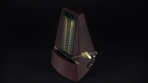 A Mechanical Device With A Pendulum To Keep The Rhythm Of Music. Video stock 327588953