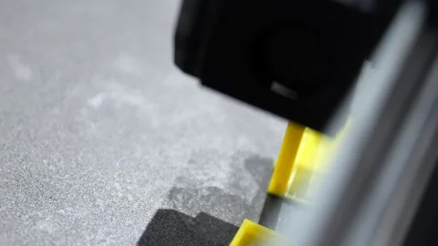 Mechanical device with yellow frame near gray pavement in macro view Stock Footage 345681530