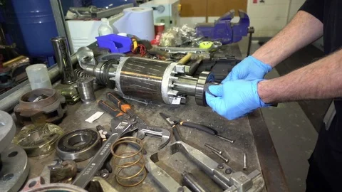 Mechanical engineer cleaning the shaft of a motor armature Stock Footage 118405376
