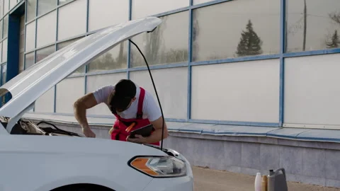 Mechanical engineer doing inspection meticulously inspects car to identify Video stock 274103302