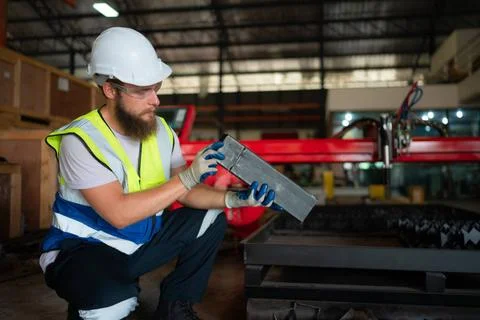 A mechanical engineer measuring product dimensions of new machinery instal... Foto stock