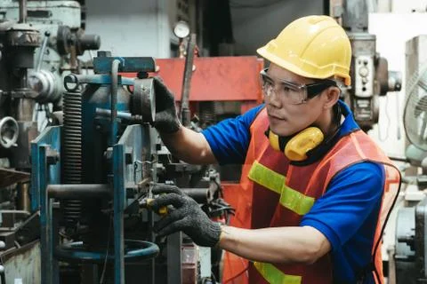 A mechanical engineer or worker at work on production in a factory. Stock Photos