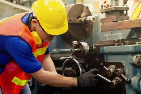A mechanical engineer or worker at work on production in a factory. Stock Photos