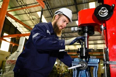 Mechanical engineer repairing engine machine at factory Foto stock