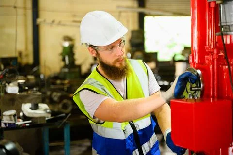 Mechanical engineer repairing engine machine at factory Foto stock