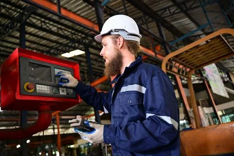 Mechanical engineer repairing engine machine at factory Stock Photos