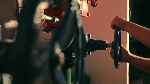 A mechanical engineer twists a large pipeline valve. Water supply shutdown. Turn Stock-Footage 165696836