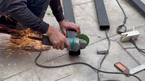 Mechanical engineer using hacksaw to cut metal frame to build the roof Stock Footage 152822027