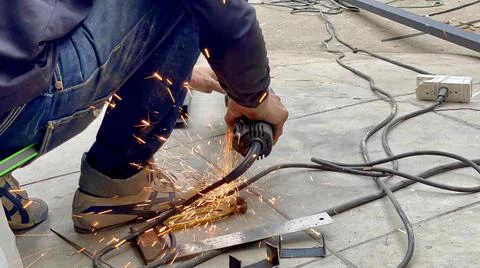Mechanical engineer using hacksaw to cut metal frame to build the roof Stock Photos