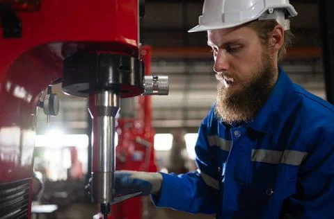 Mechanical engineers are checking the working condition of the new machine... 写真素材