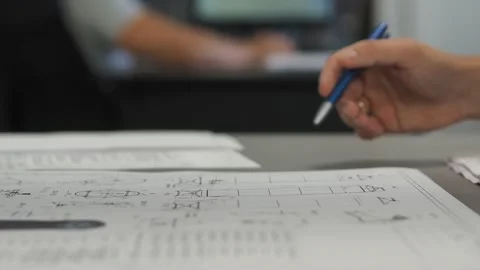 Mechanical engineers, designers discuss problems on blueprints. Slide Stock Footage 151663242