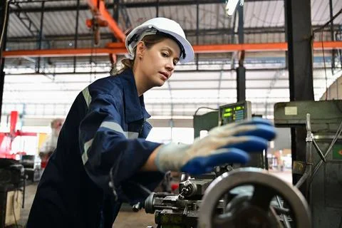 Mechanical engineers repairing engine machine at factory Stock Photos