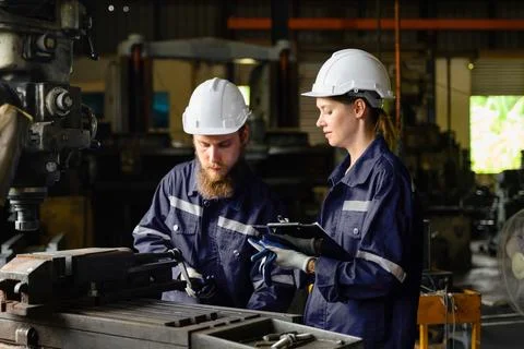 Mechanical engineers repairing engine machine at factory 写真素材