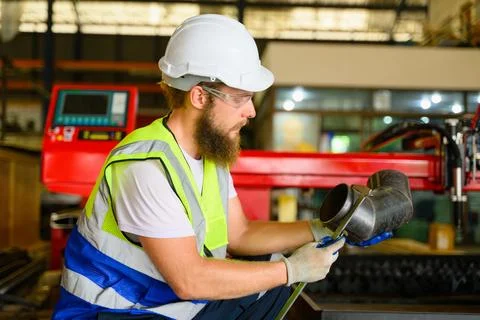 Mechanical engineers repairing engine machine at factory Stock Photos