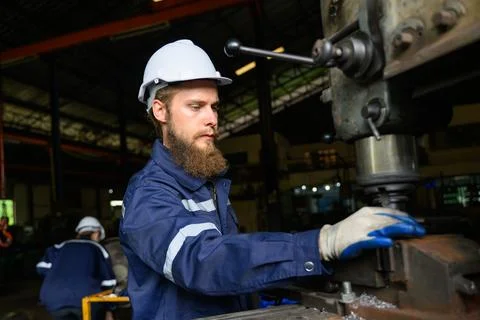 Mechanical engineers repairing engine machine at factory 写真素材