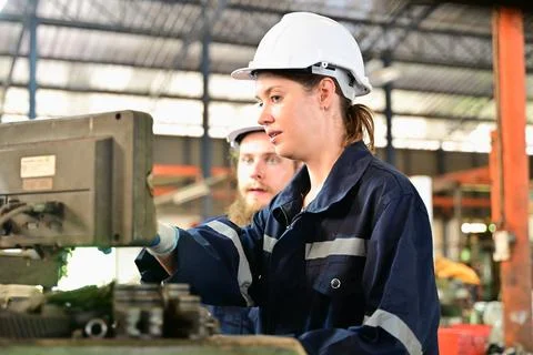 Mechanical engineers repairing engine machine at factory Stock Photos
