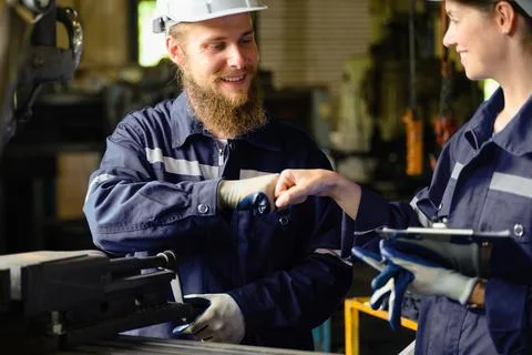 Mechanical engineers repairing engine machine at factory 写真素材