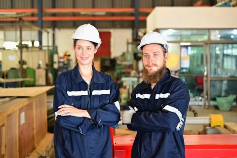 Mechanical engineers repairing engine machine at factory 写真素材